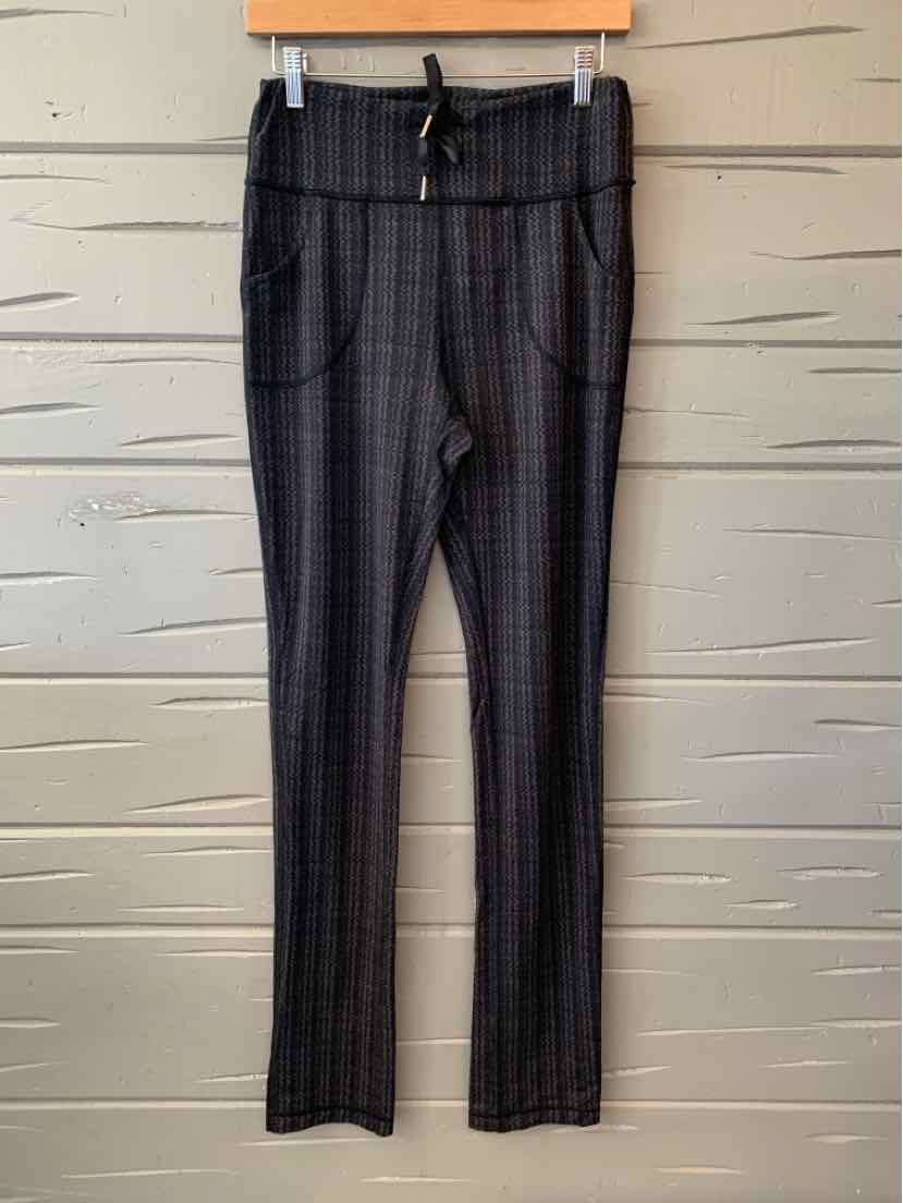 Black and gray plaid women's leggings with front pockets and adjustable drawstring waistband.