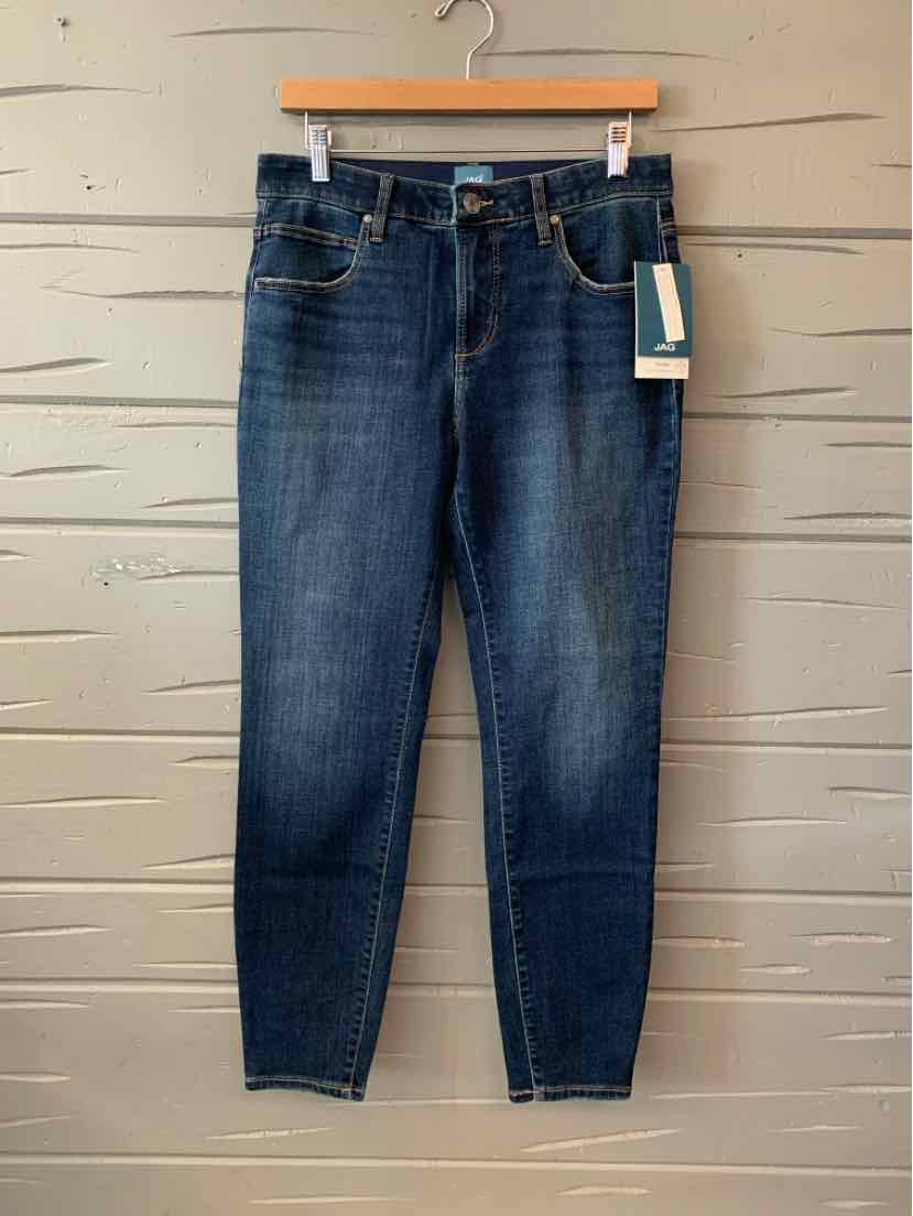 Dark blue slim-fit jeans with five-pocket design and front button closure hanging on wooden hanger.