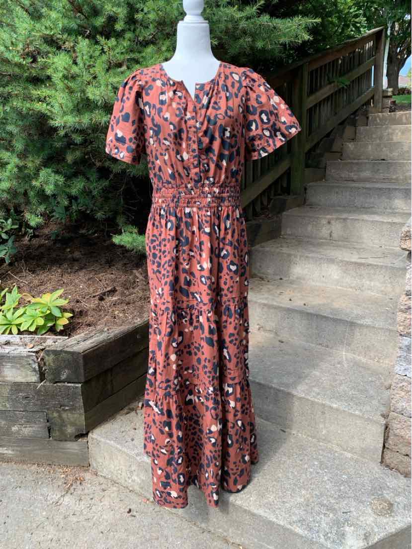 Brown cheetah print midi dress with short puff sleeves and cinched waist.