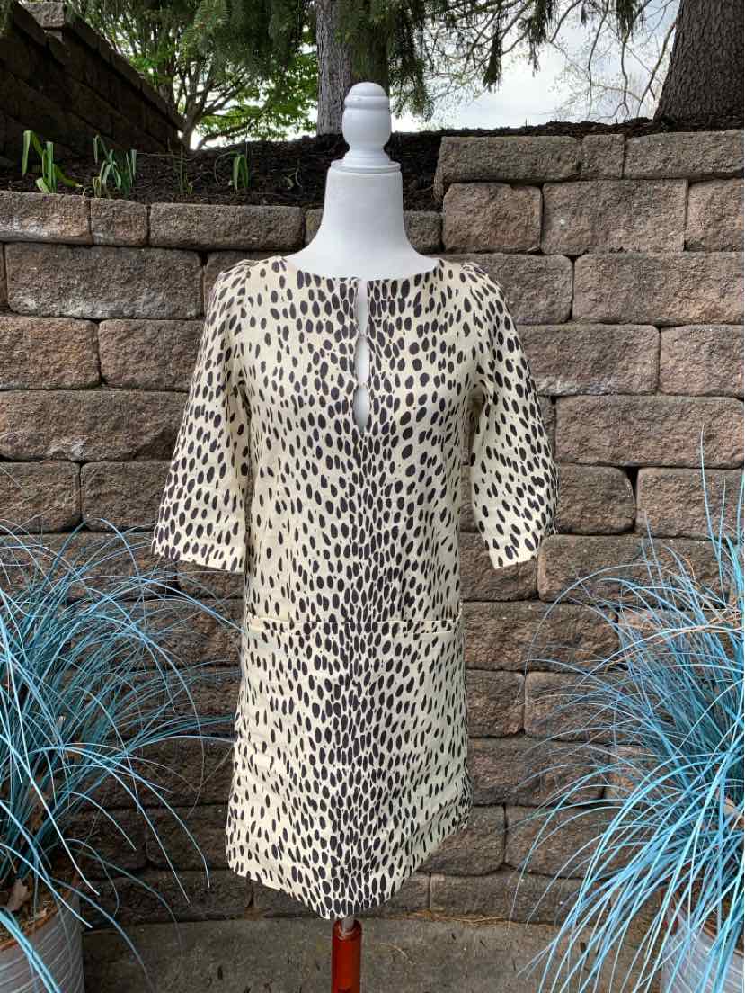 Beige and black leopard print knee-length dress with elbow-length sleeves on white mannequin.