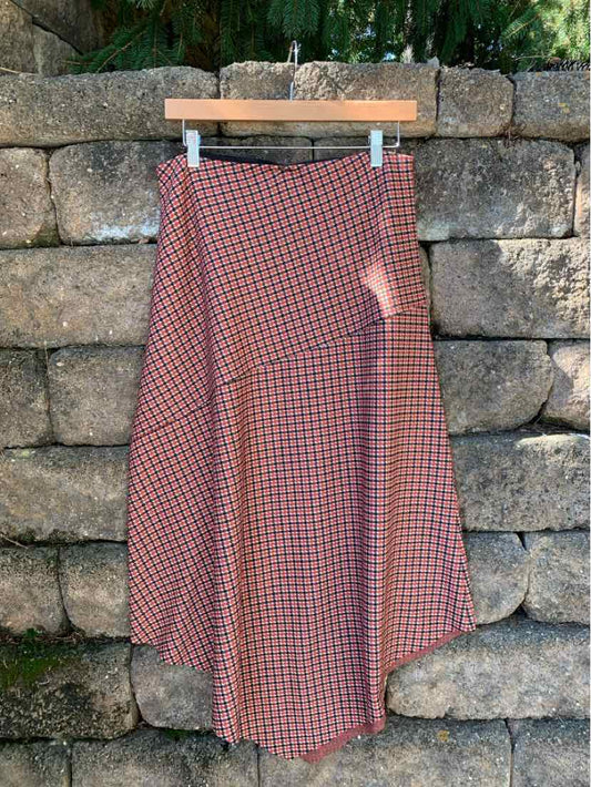 Red and navy houndstooth A-line skirt with a high waist and a flowing midi-length hem.