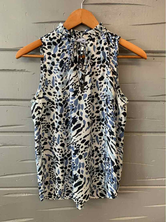 Sleeveless blouse with high neck and black, gray, and blue animal print on white background.