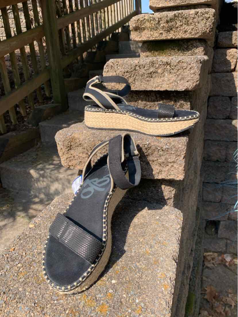 Black wedge sandals with ankle straps and braided jute platform soles, size 8.5.