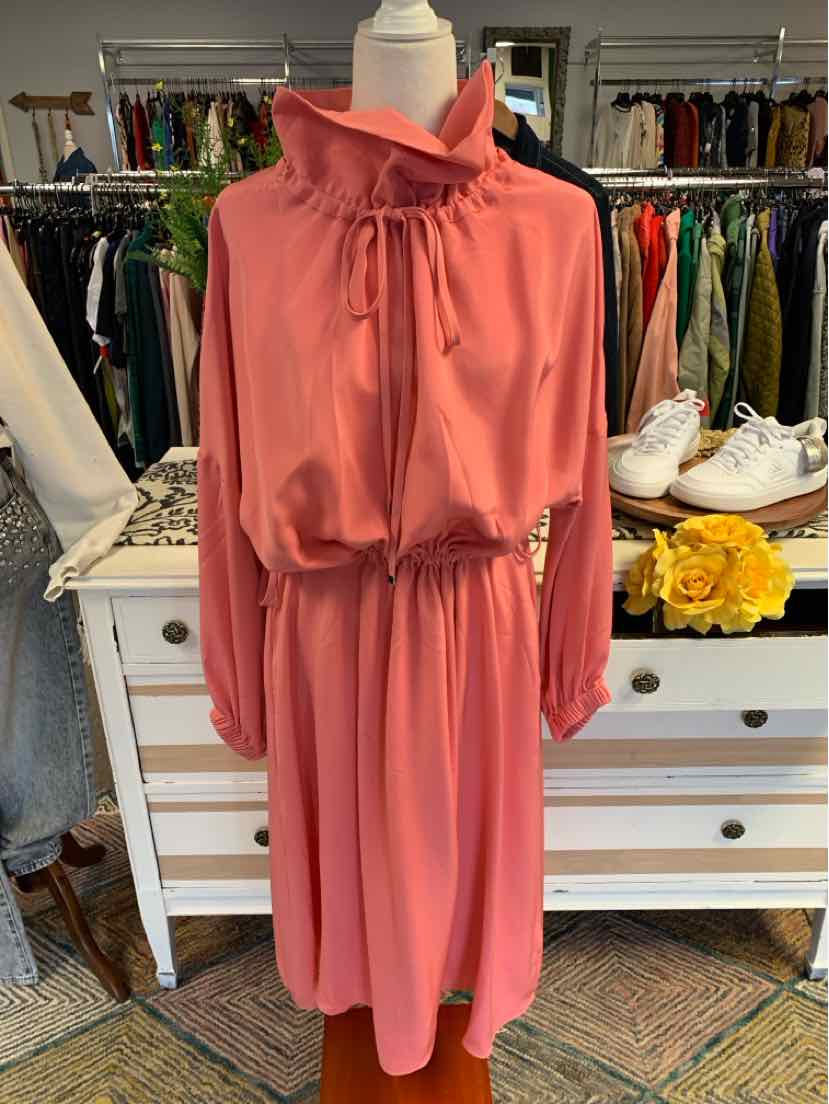 Long-sleeve pink dress with high ruffled collar and cinched waist, flowy skirt design.