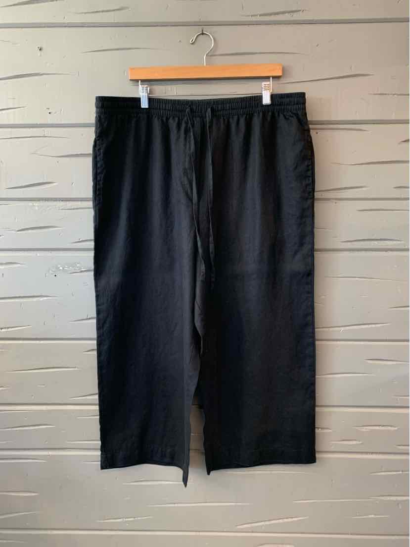 Black wide-leg linen pants with elastic waistband, size XL, hanging on wooden hanger.