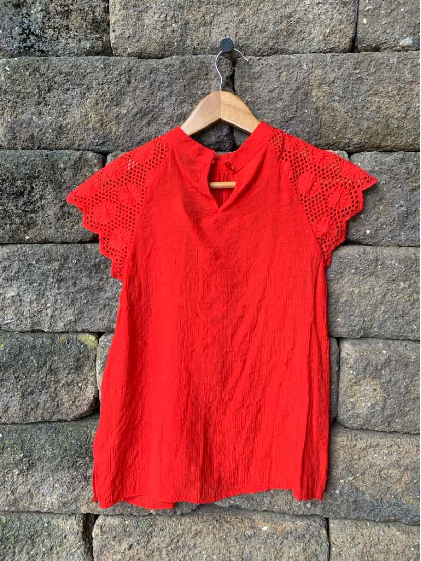 Red short-sleeve blouse with textured fabric and delicate lace detailing on sleeves, medium size.