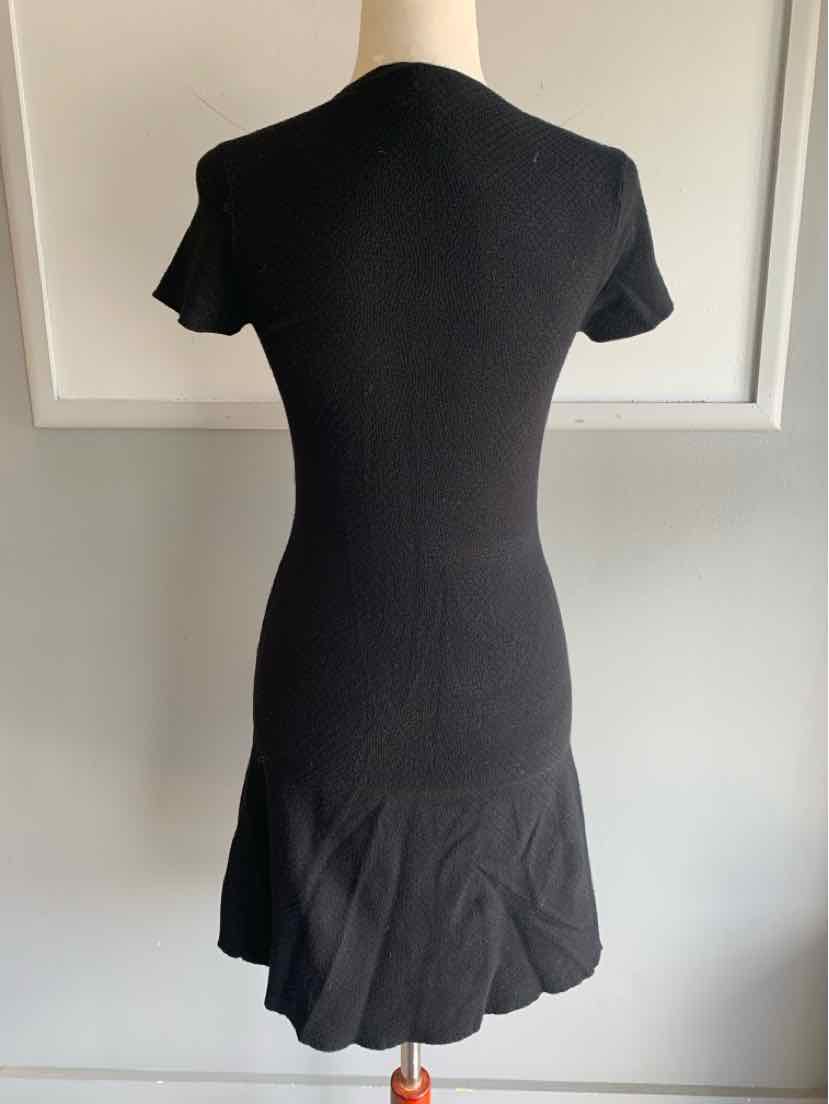 Black short-sleeve fitted dress with a ruffled hem, knee-length, soft fabric.