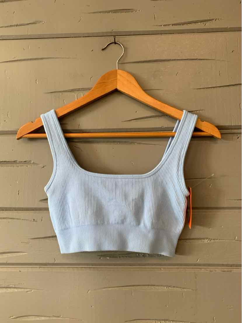 Light blue ribbed knit cropped tank top with wide straps on wooden hanger.