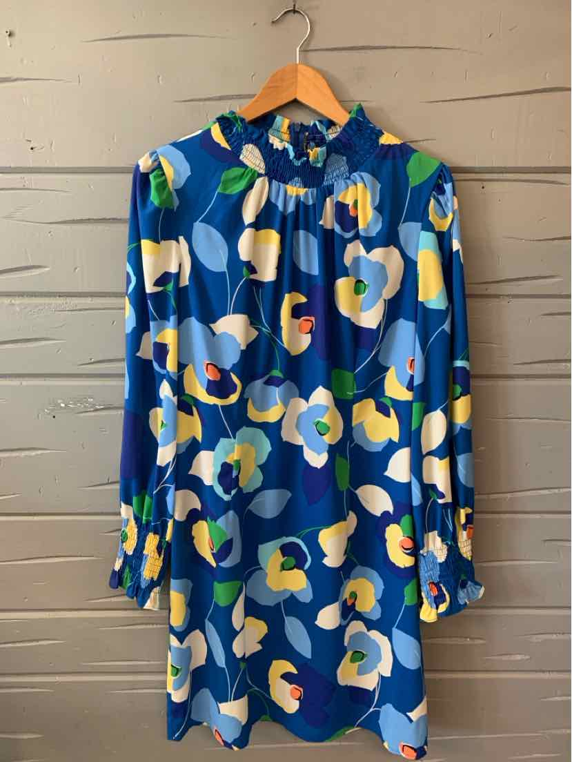 Blue floral long-sleeve dress with high neckline and loose fit on wooden hanger.