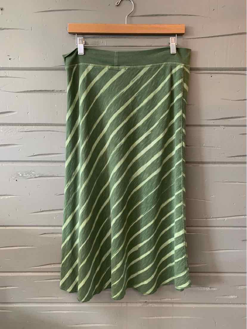 Green midi skirt with white diagonal stripes and flared hem hanging on wooden hanger.