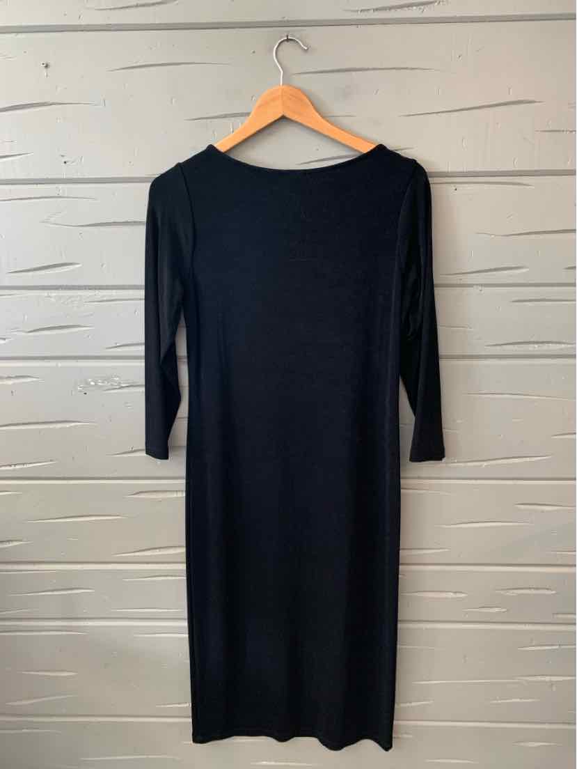 Black knee-length dress with three-quarter sleeves and boat neckline on wooden hanger.
