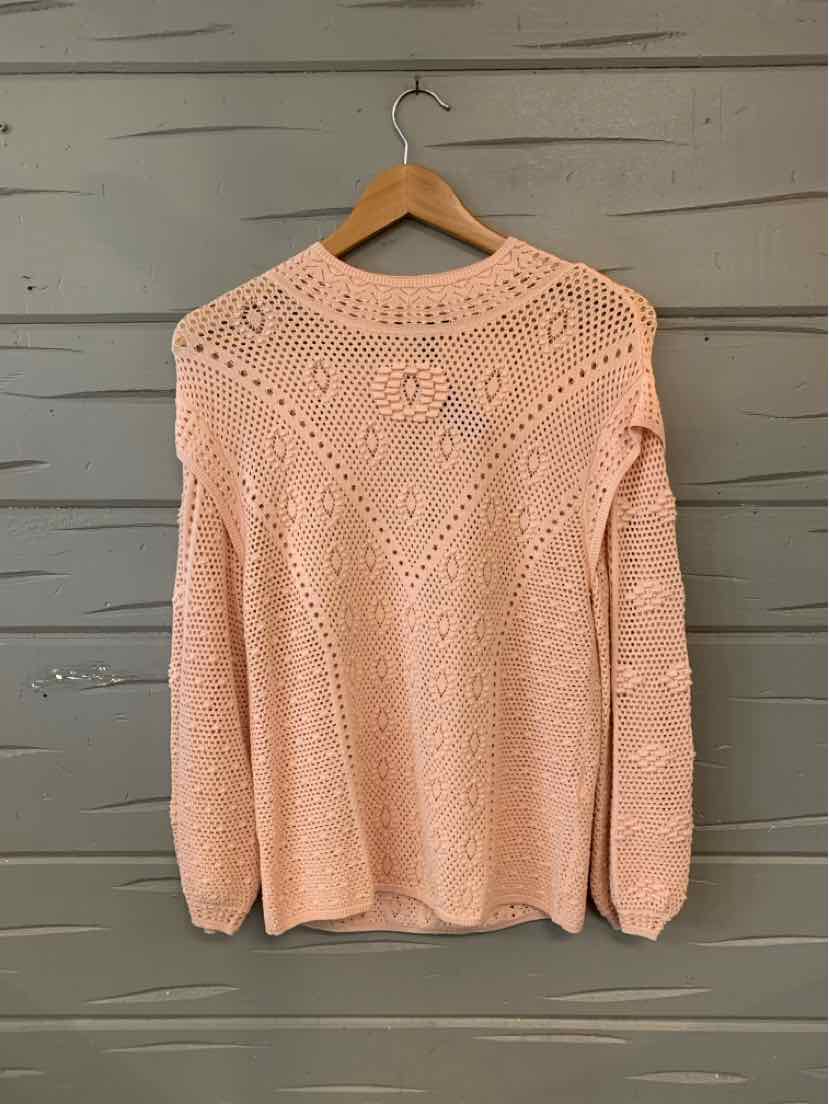 Light pink open-knit sweater with textured diamond and floral patterns, long sleeves, and crew neck.