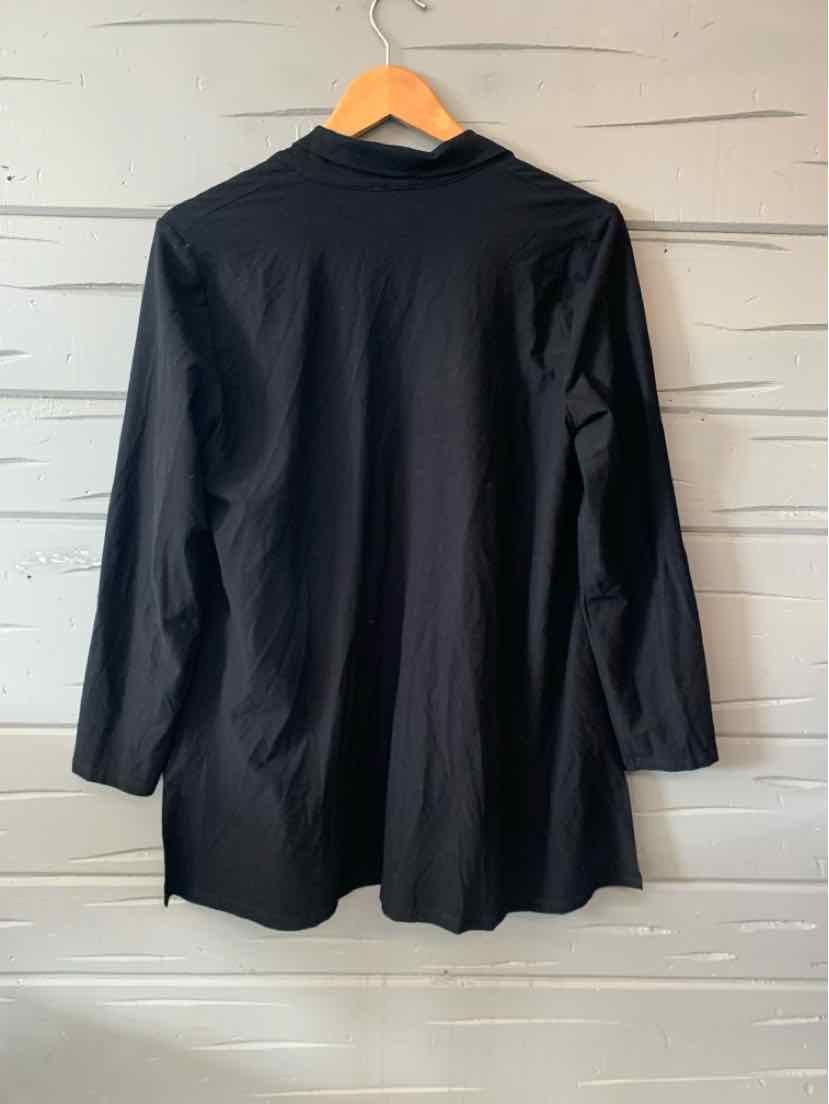 Black long-sleeve tunic with a loose fit and soft, smooth fabric hanging on a wooden hanger.