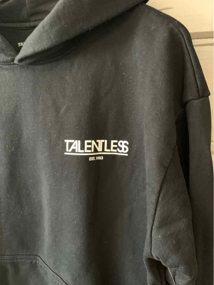 Black oversized hoodie with white TALENTLESS logo and "EST. 1998" text on chest.