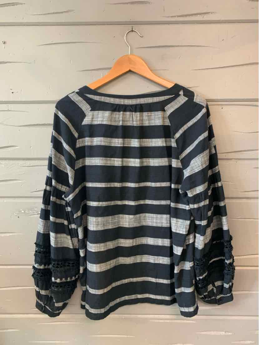 Black and white striped long-sleeve blouse with ruffled sleeve details and a relaxed fit.