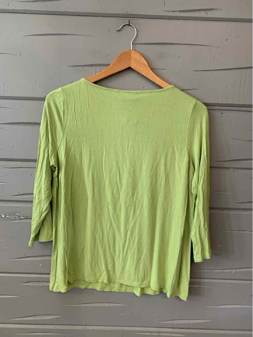 Light green long-sleeve lightweight knit top with a relaxed fit on wooden hanger.