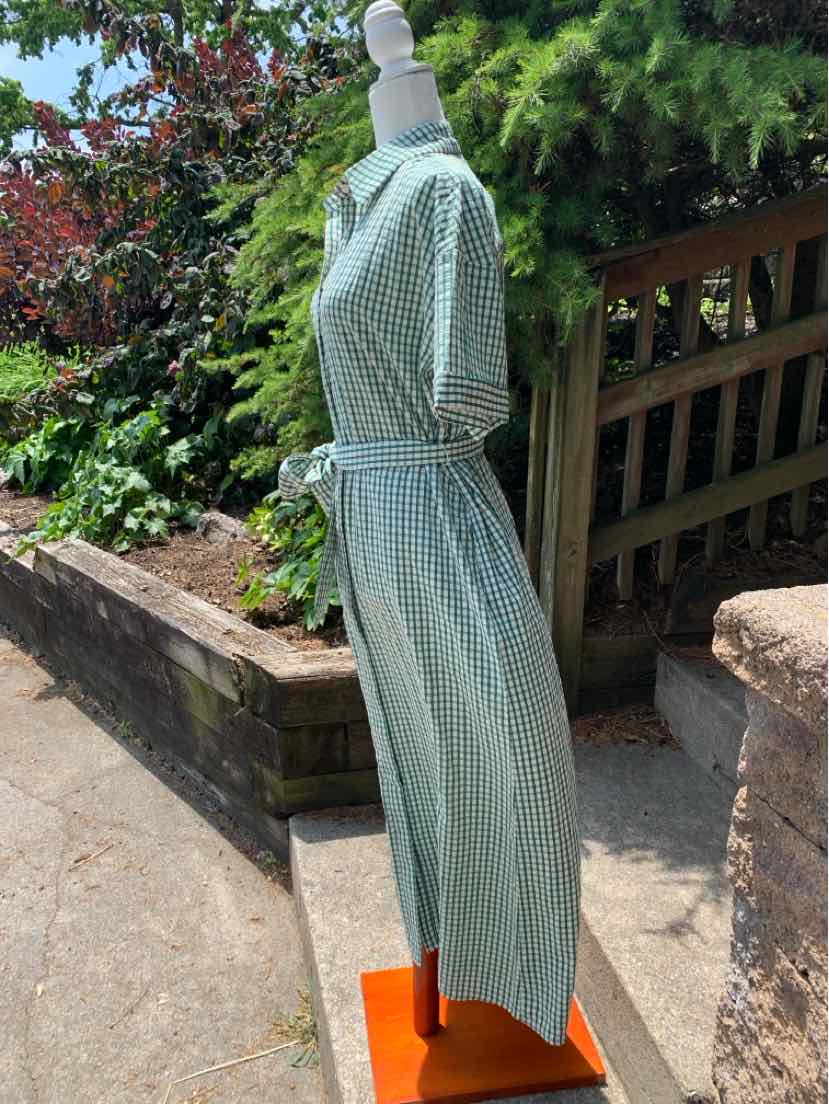 Teal gingham dress with short sleeves, cinched waist, and midi length displayed on mannequin outdoors.