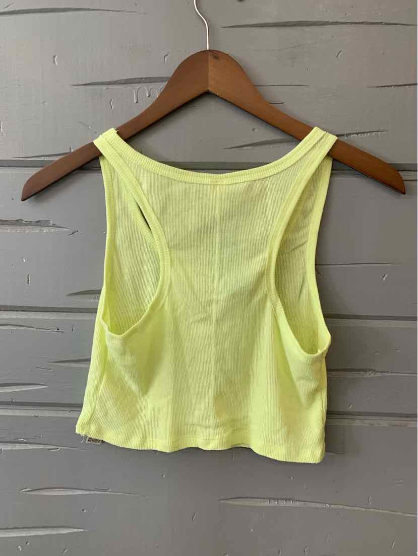 Yellow sleeveless cropped tank top with wide shoulder straps on wooden hanger.