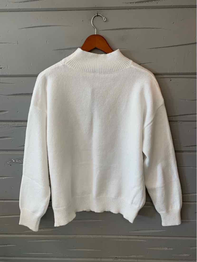 White long-sleeve crewneck sweatshirt with ribbed cuffs and hem, hanging on a wooden hanger.