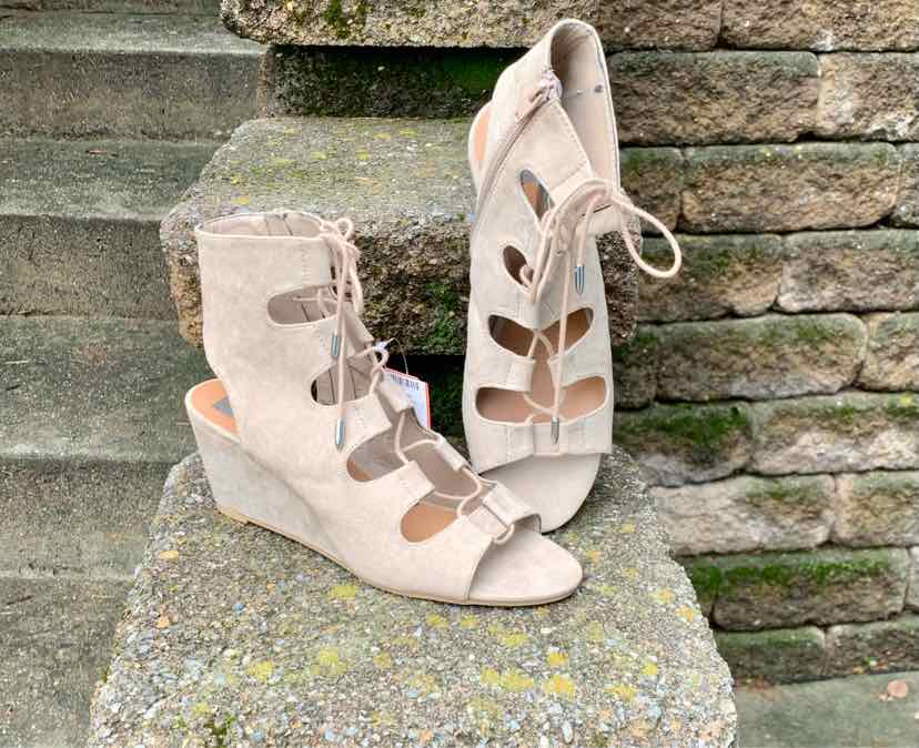Beige suede gladiator wedge sandals with open toes and lace-up front, size 8.