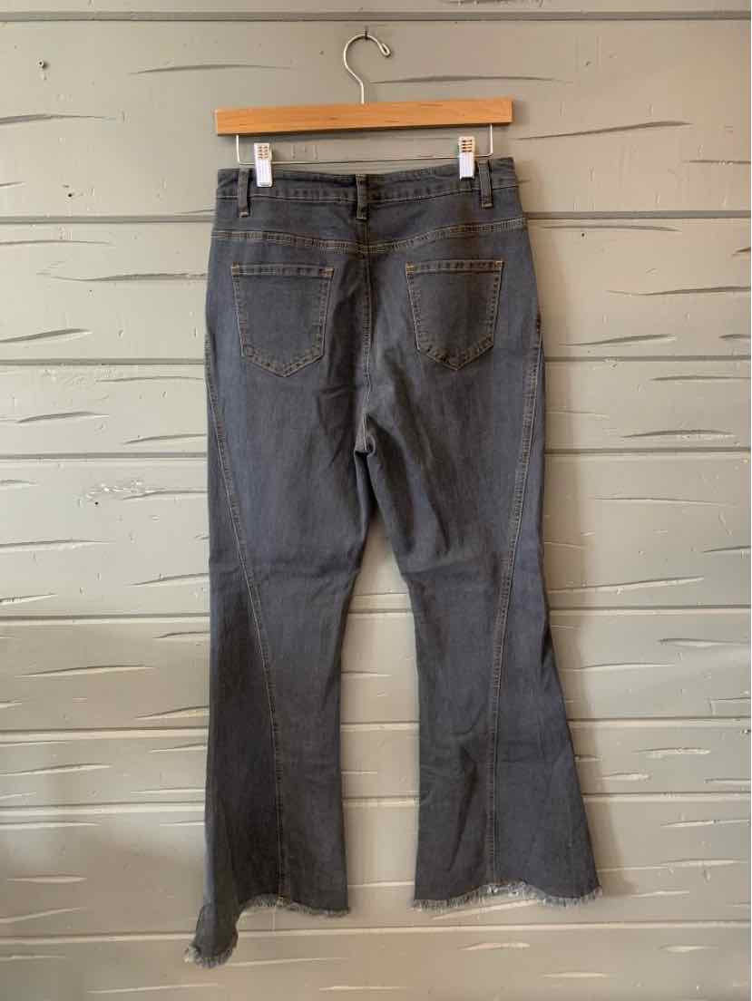 Gray mid-rise straight-leg jeans with raw hem and back pockets hanging on wooden hanger.