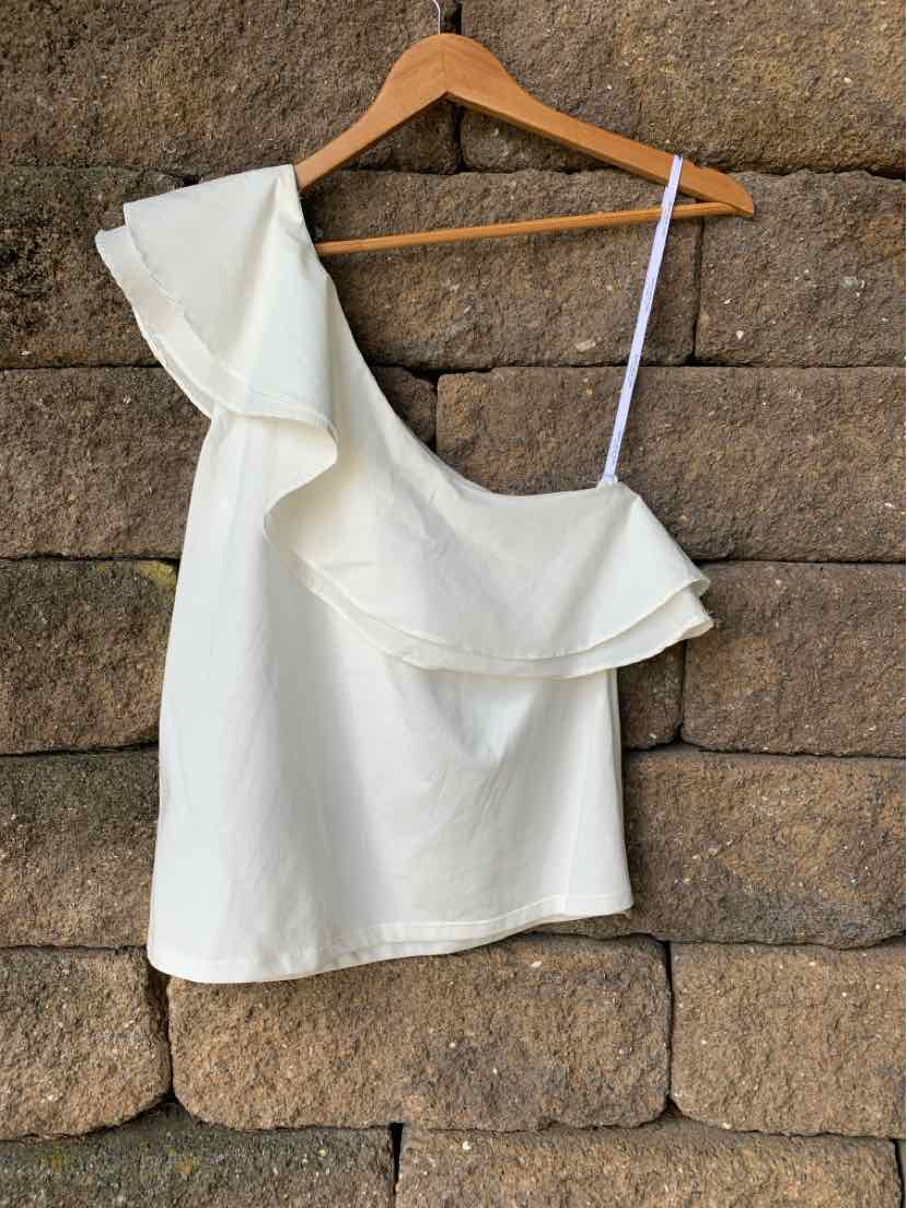 White one-shoulder sleeveless top with ruffle trim and thin strap, lightweight fabric.