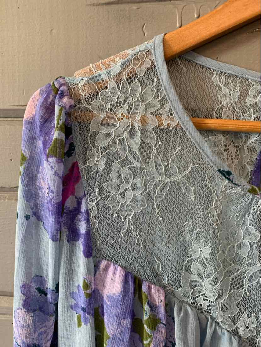 Light blue floral dress with lavender and purple flowers, lace yoke, and gathered waist.