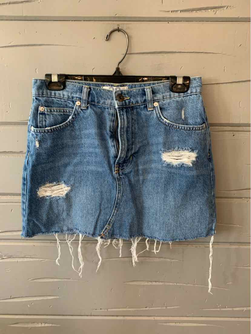 Light blue distressed denim mini skirt with frayed hem and front pockets.
