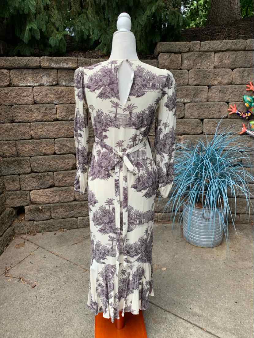 Long-sleeve midi dress with purple and white abstract print, fitted waist, and gathered back detail.