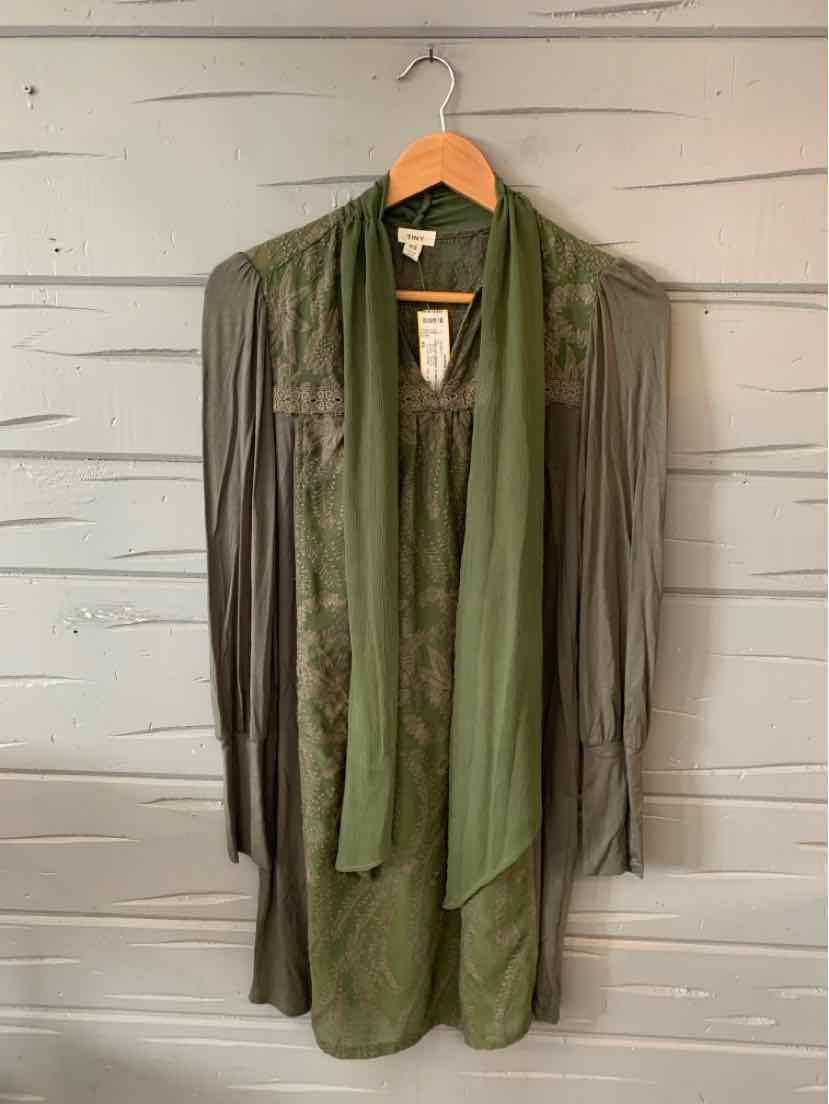 Lightweight olive green cardigan with long sleeves and open front hanging on wooden hanger.