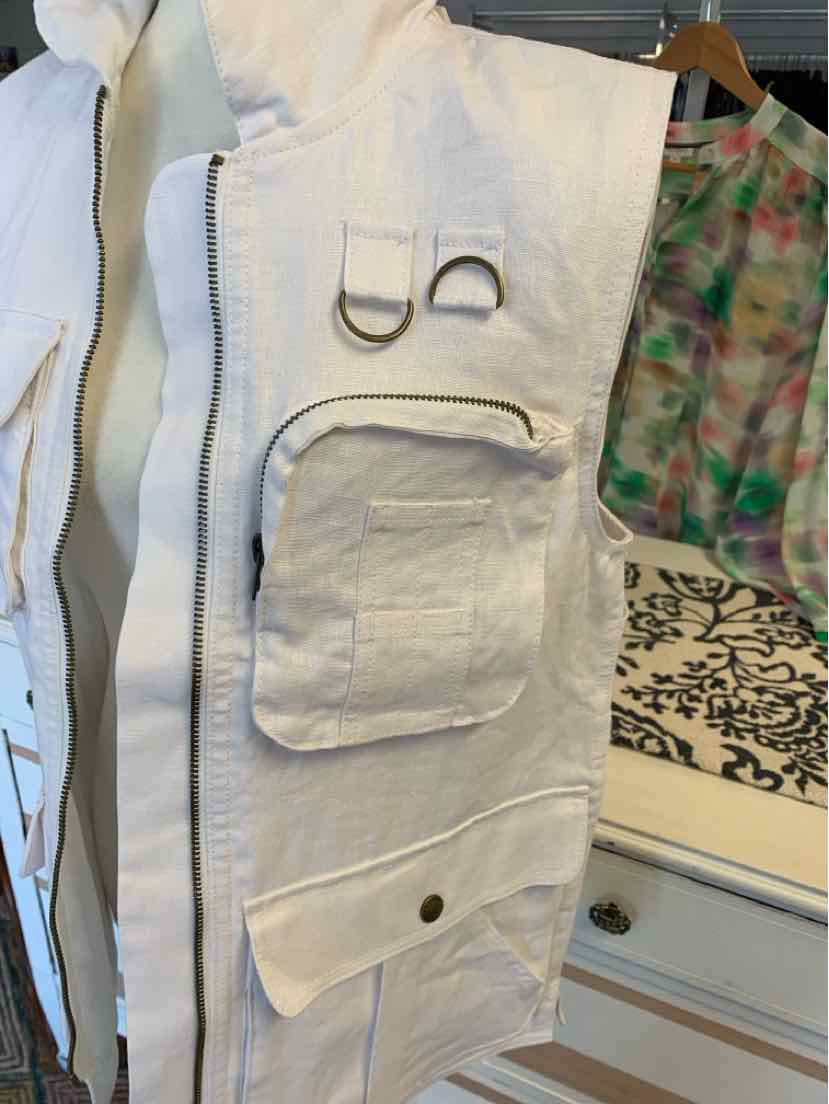 White linen utility vest with front zipper, multiple pockets, and metal D-rings in XS size.