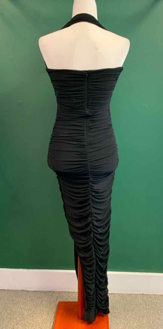 Black ruched bodycon dress with strapless neckline and fitted silhouette.