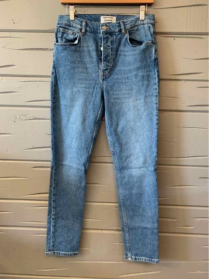 Blue denim jeans with classic five-pocket design, slim fit, and slight fading for casual style.