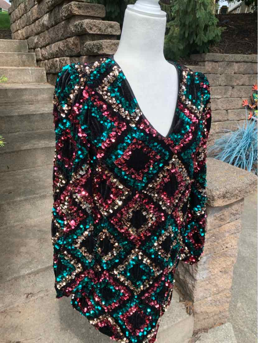 Long-sleeve dress with deep V-neck, covered in multicolored sequins forming diamond patterns.