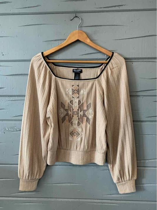 Tan long-sleeve blouse with square neckline and Aztec pattern print on front.