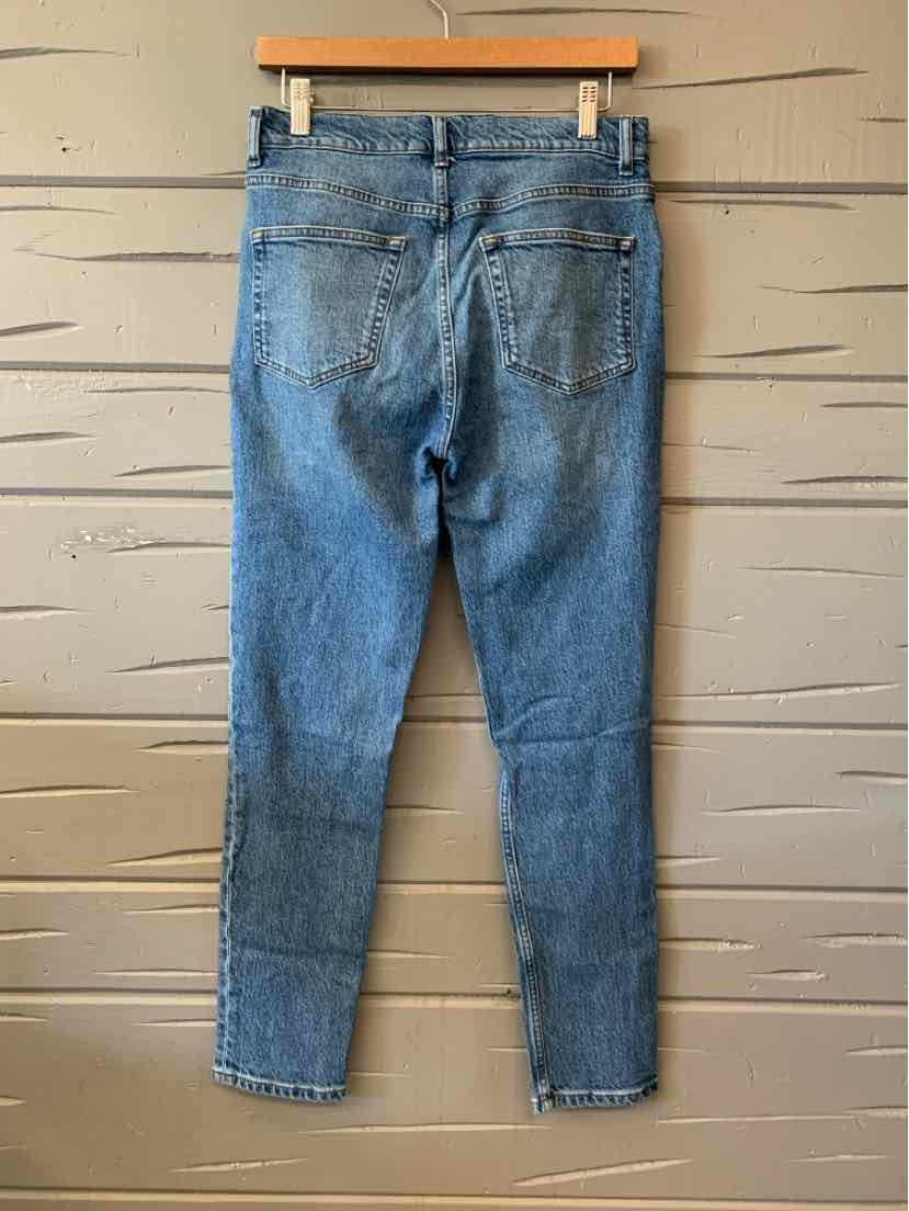 Blue denim jeans with back pockets, tailored for women’s casual and activewear clothing.