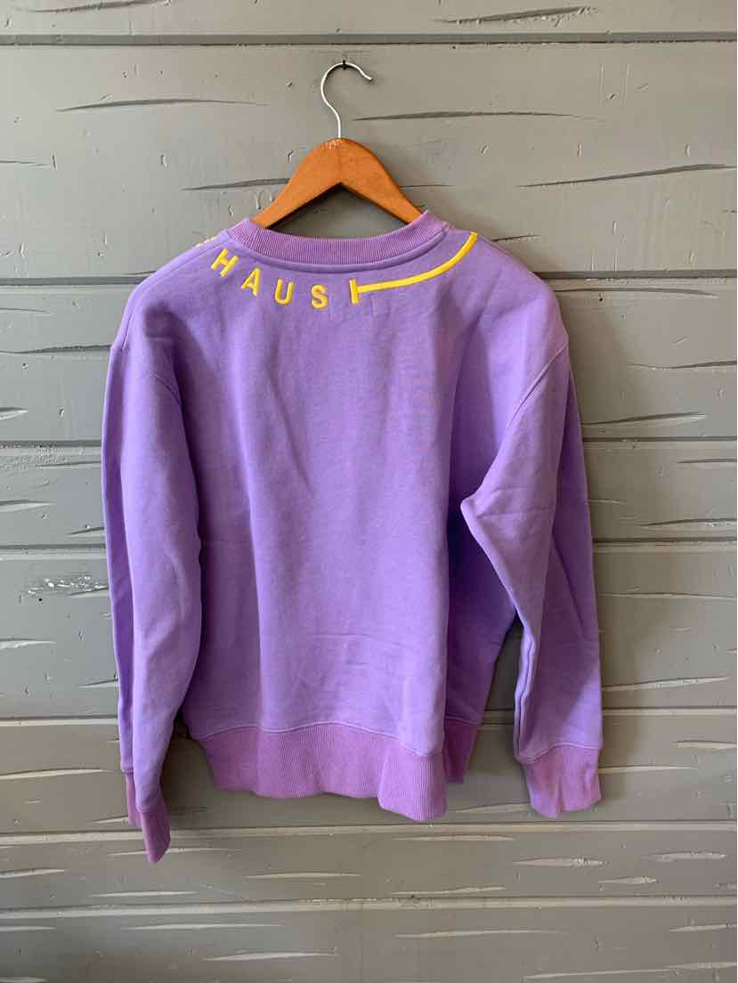Lavender crewneck sweatshirt with yellow "HAUS" lettering near the neckline on the back.
