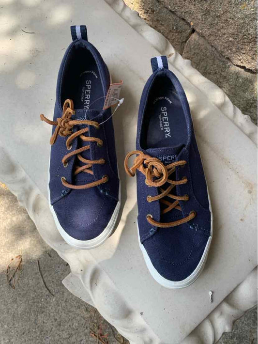 Navy blue Sperry casual sneakers with white soles and brown laces, size 8.5, lace-up design.