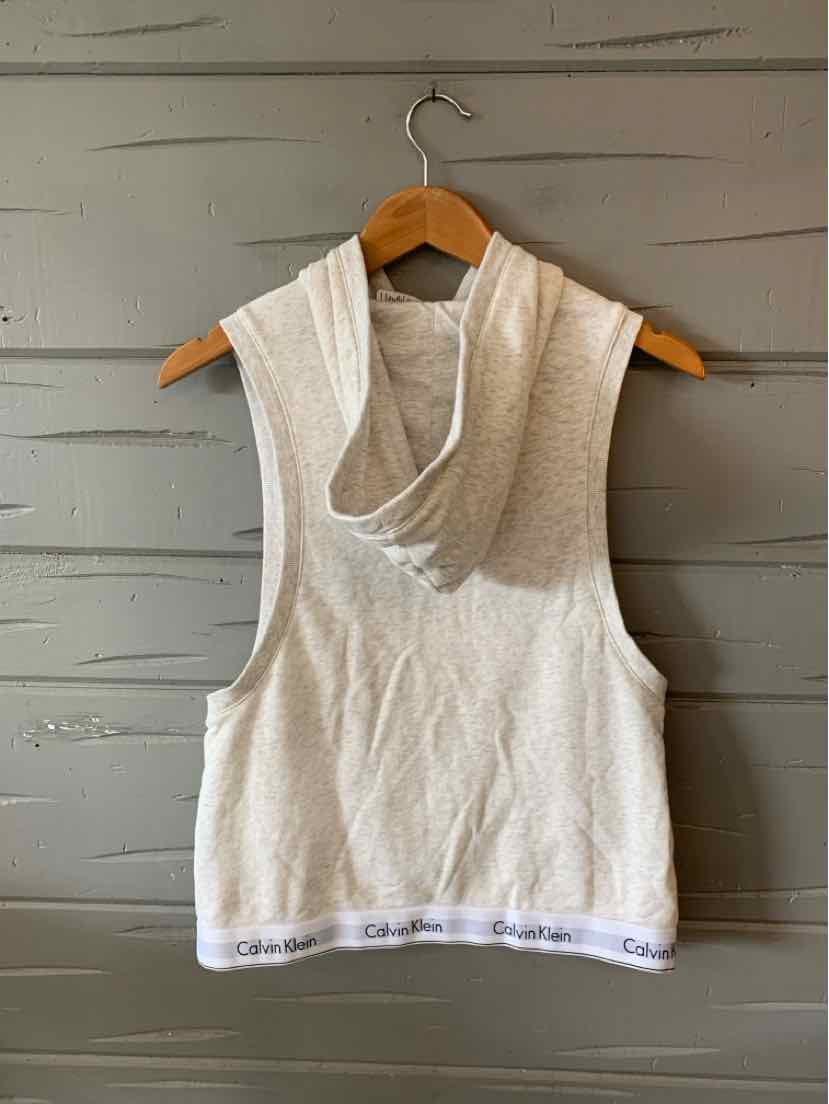 Light gray sleeveless hoodie with relaxed fit and white elastic waistband featuring Calvin Klein logo.