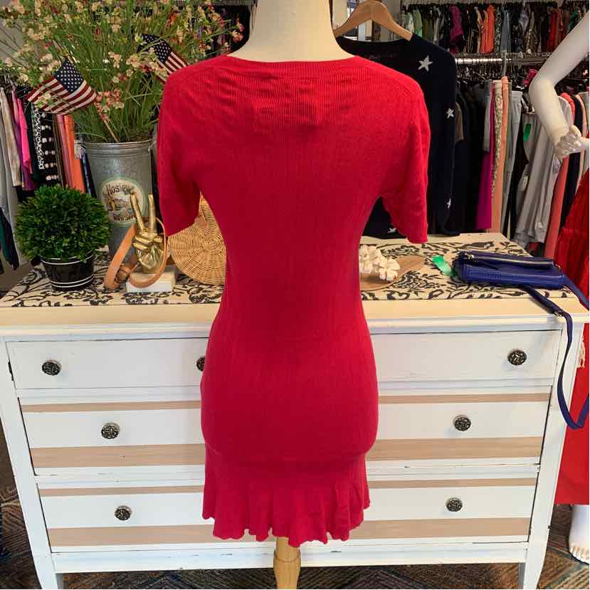 Fuchsia knit dress with short sleeves and ruffled hem on mannequin.