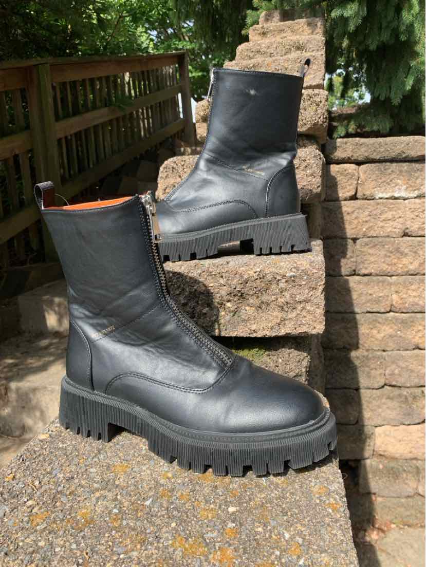 Black mid-calf leather boots with chunky lug soles and rounded toes, size 7.5.