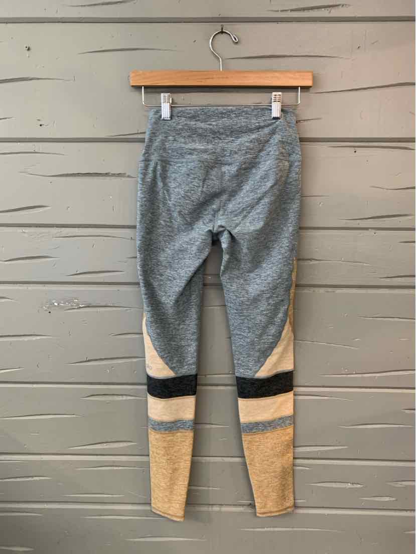 Gray high-waisted leggings with black, white, and beige color block panels on lower legs.