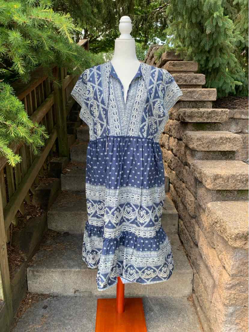 Blue and white boho midi dress with cap sleeves, V-neckline, and tiered skirt detailing.