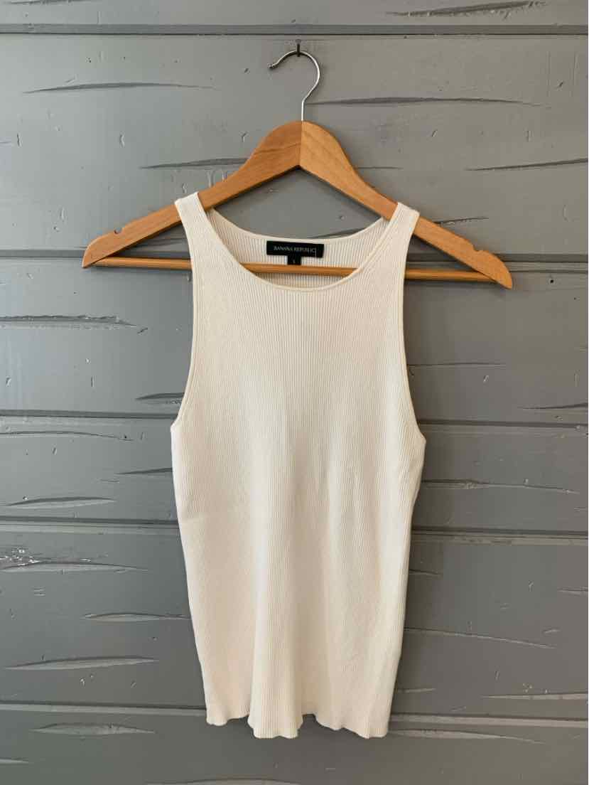 White ribbed sleeveless tank top with scoop neckline on wooden hanger.