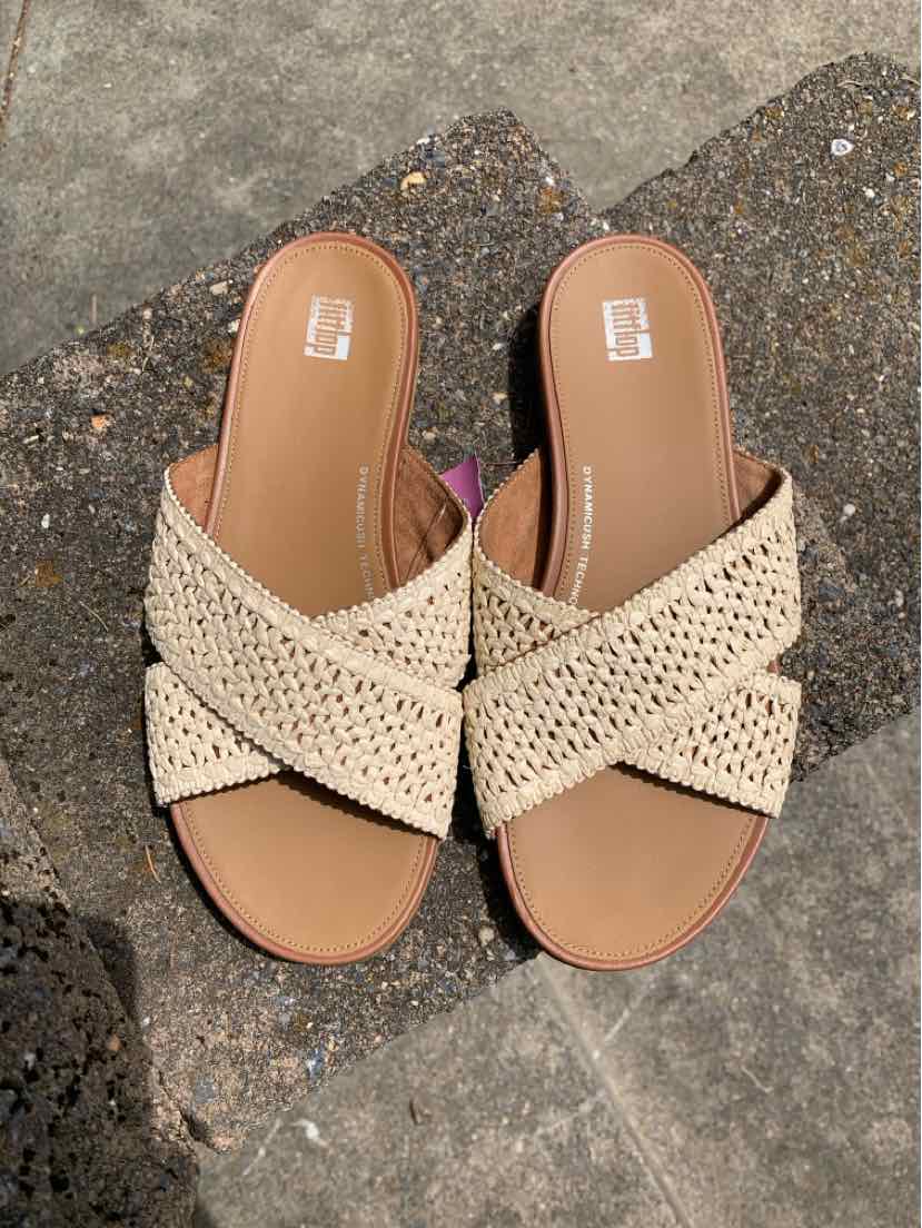 Tan raffia sandals with crisscross straps and cushioned footbed, size 8.