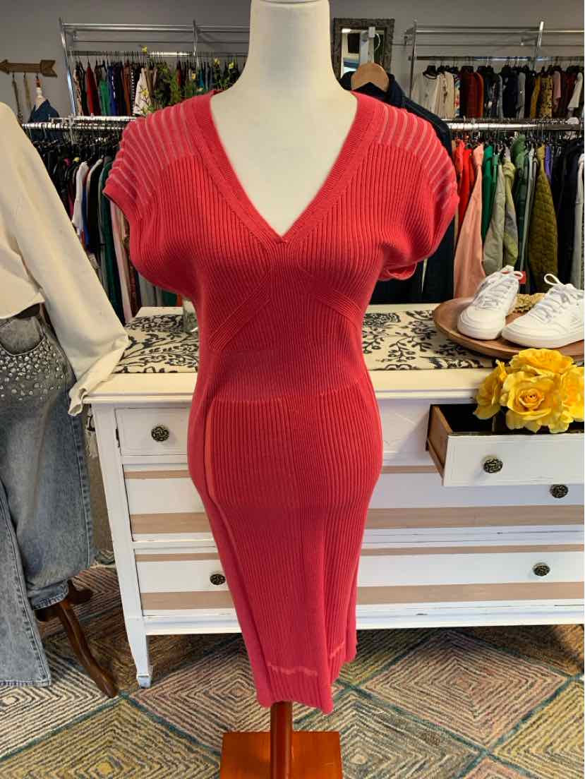 Medium pink ribbed knit dress with short sleeves and V-neck on mannequin.