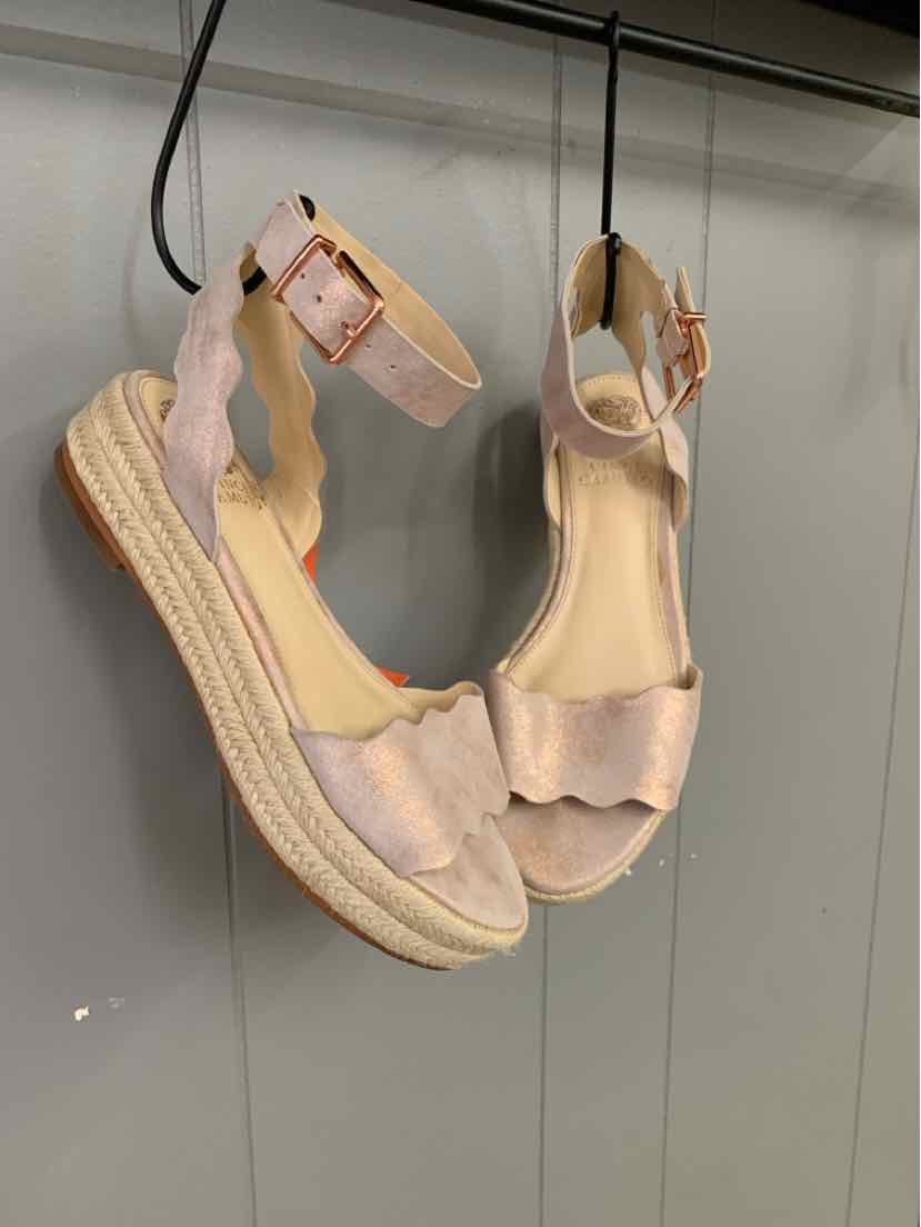 Rose gold wedge sandals with scalloped straps and ankle buckle, espadrille-style sole.