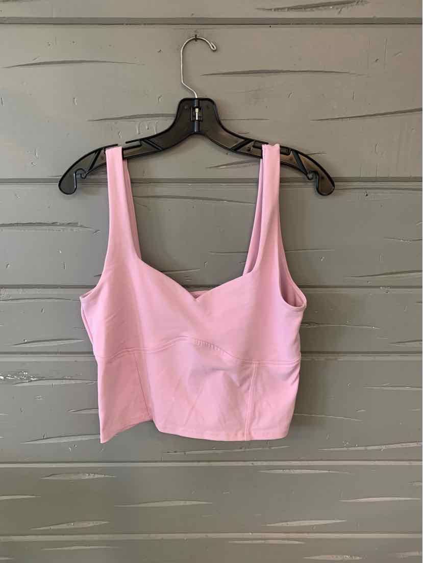 Light pink cropped tank top with wide straps and square neckline hanging on black hanger.