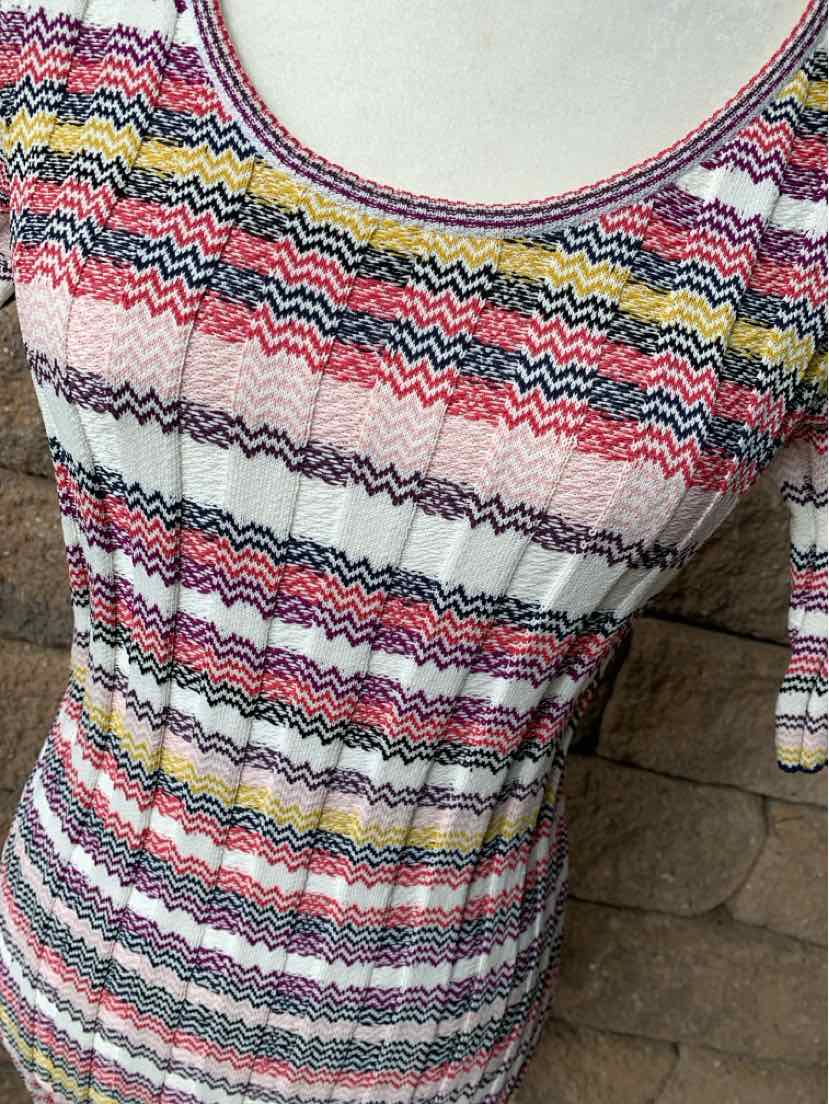 Fitted scoop neck top with colorful zigzag stripes in pink, blue, yellow, and white on a ribbed knit fabric.
