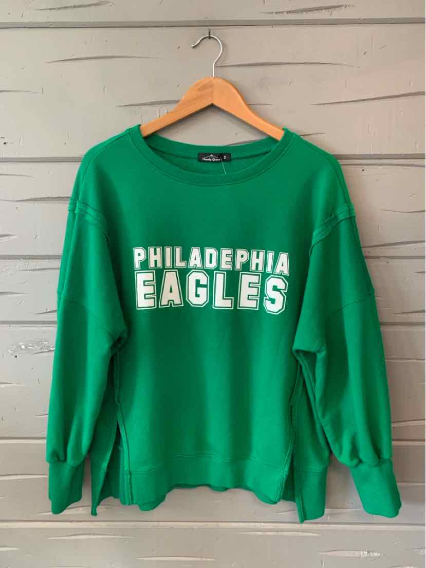 Green crewneck sweatshirt with "Philadelphia Eagles" printed in white, relaxed fit.